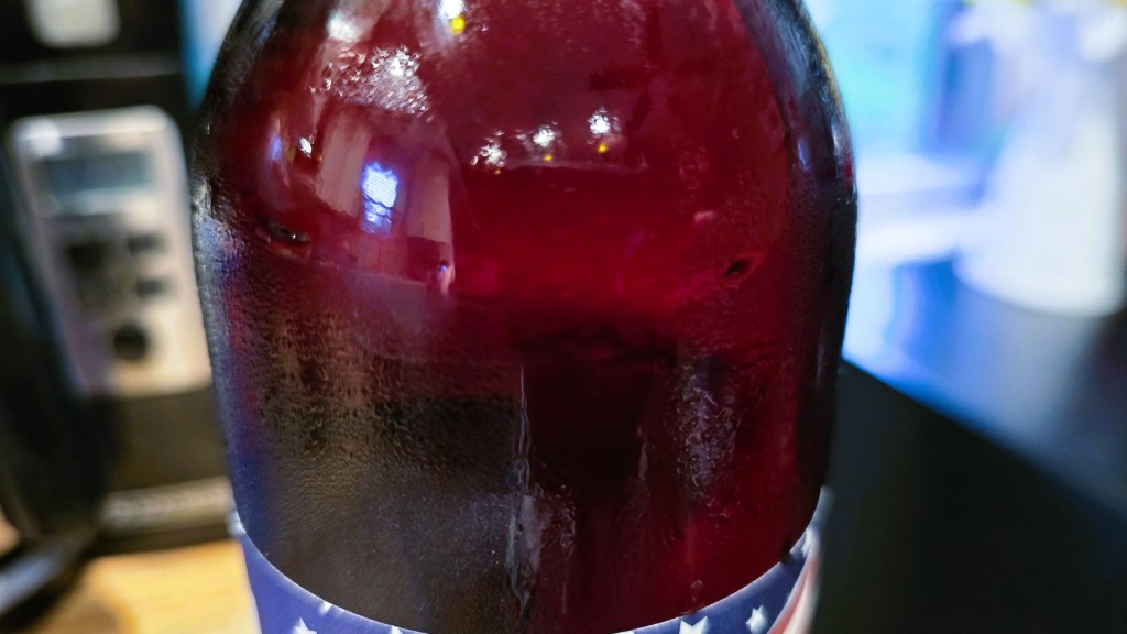 A view of the light red wine in the wine bottle.