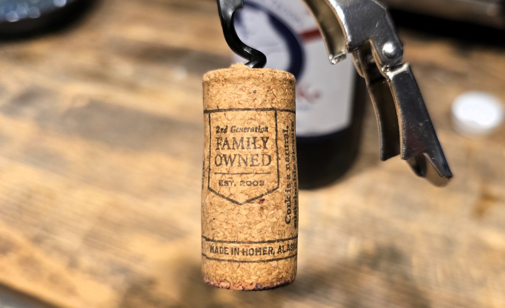 Close up view of wine cork. Text on the cork says the winery is family owned in Homer, Alaska.