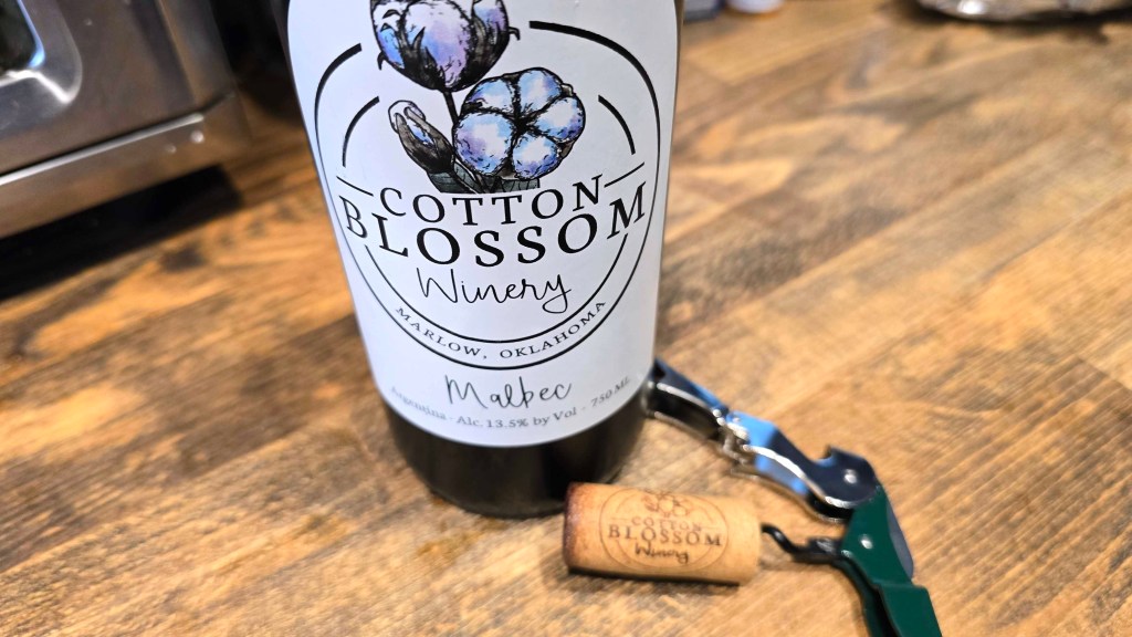 Wine bottle with a label that reads Botton Blossom Winery Malbec.